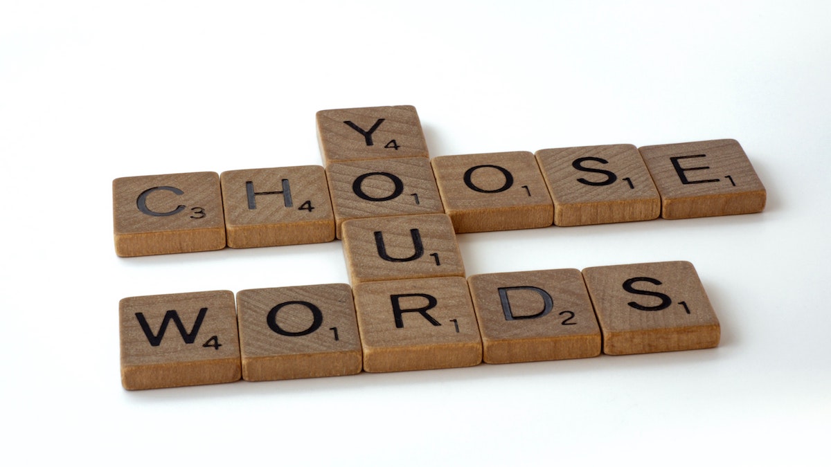 Scrabble pieces that spell out the phrase, "Choose your words"